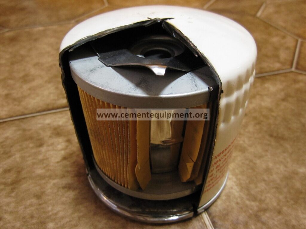 Oil filter cutaway showing the filter element and bypass valve mechanism for lubrication oil filter bypass diagnosis
